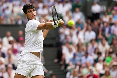 Carlos Alcaraz plays a forehand return to Mark Lajal